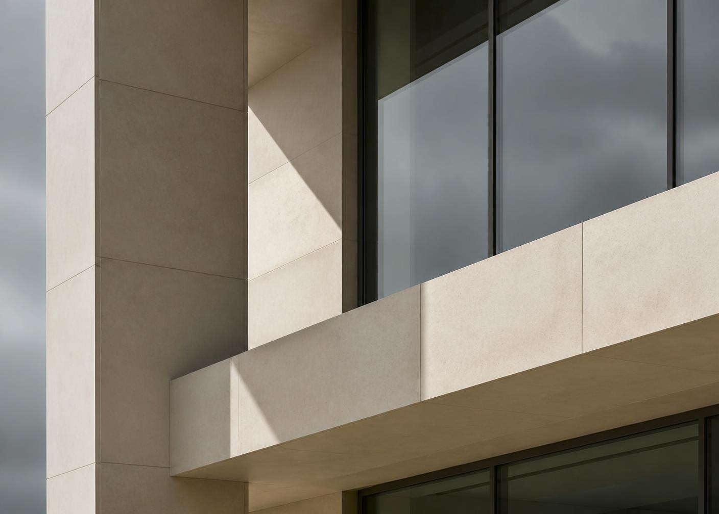 Detail of a restrained stone and glass facade under overcast light