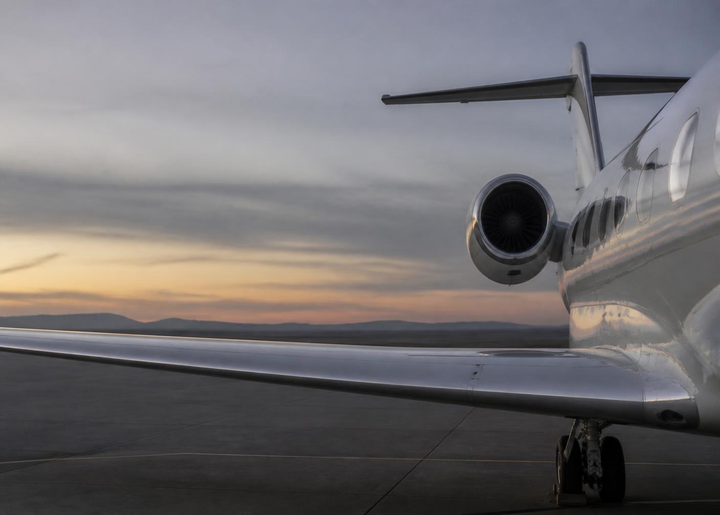 A private aircraft on a quiet apron at dusk